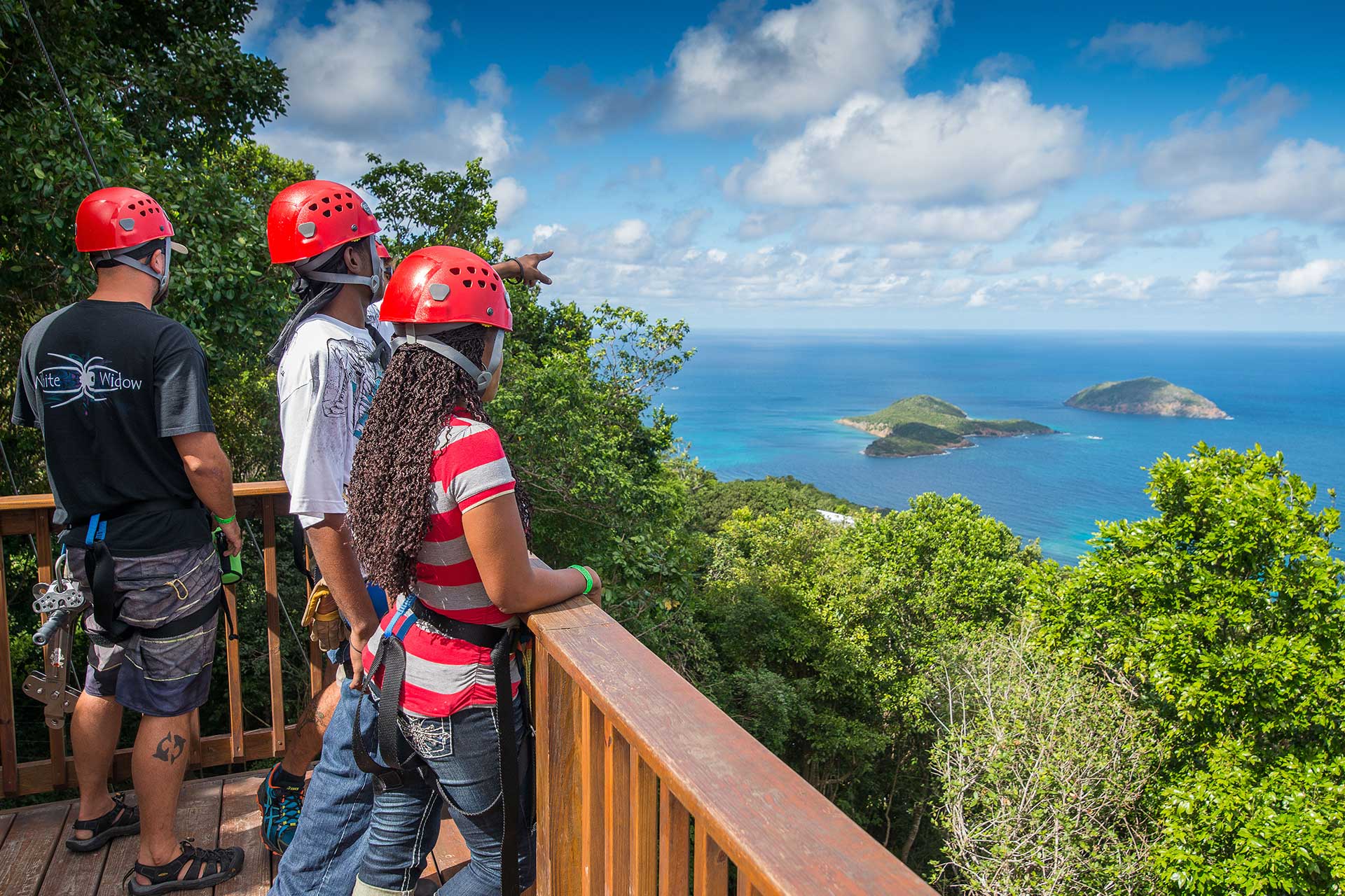 Guests pointing and admiring the views from the platforms of the zipline in St. Thomas.