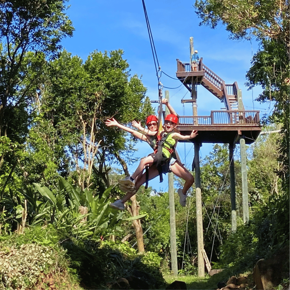 Tandem ziplining. Mom and son ziplining together on the famous "yo-yo" zipline in St. Thomas at Tree Limin' Extreme